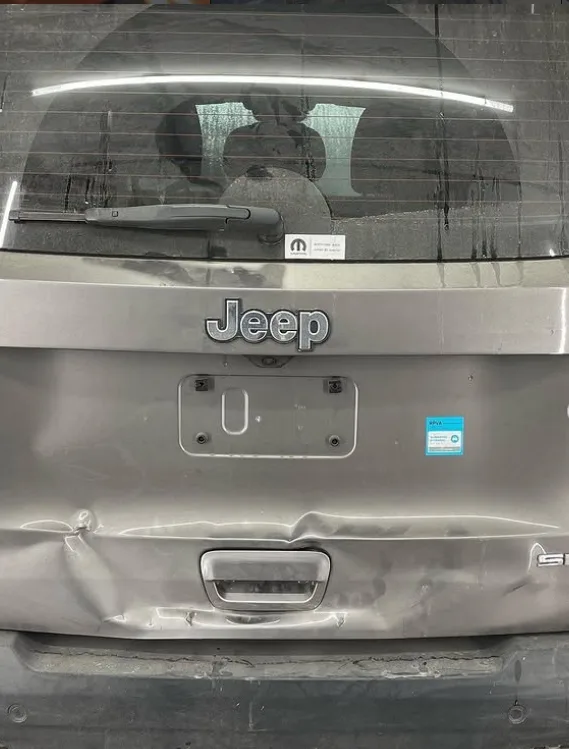 Portón trasero de un Jeep chocado, antes de la reparación